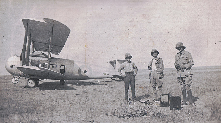 Cyril Ellen (centre) and two others standing with Vickers Vernon J6868 on a desert mud flat. Cyril Ellen (centre) and two others standing with Vickers Vernon J6868 on a desert mud flat.